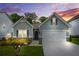 Charming single-story home with gray siding, a two-car garage, and a well-manicured front yard at 9010 Jim Purcell Dr, Covington, GA 30014