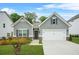 Charming single-story home with gray siding, a two-car garage, and a well-manicured front yard at 9010 Jim Purcell Dr, Covington, GA 30014