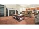 Comfortable living room featuring a fireplace, plush sofa, and an adjacent eat-in kitchen at 9010 Jim Purcell Dr, Covington, GA 30014
