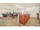 Open-concept living area with modern lighting, hardwood floors, and a seamless flow to the dining and living spaces at 9010 Jim Purcell Dr, Covington, GA 30014