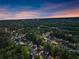 Picturesque aerial view of a neighborhood nestled among lush trees at twilight at 2040 Parliament Dr, Lawrenceville, GA 30043