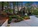 Landscaped backyard featuring a charming wooden swing, a storage shed and a glimpse of a refreshing swimming pool at 2040 Parliament Dr, Lawrenceville, GA 30043