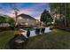 A sprawling backyard features a lush lawn, inviting pool, and comfortable seating for outdoor enjoyment and relaxation at 2040 Parliament Dr, Lawrenceville, GA 30043