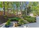 Serene backyard featuring a swing, garden, shed, and lush greenery at 2040 Parliament Dr, Lawrenceville, GA 30043