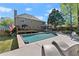 A lovely backyard showcasing a swimming pool, screened porch, and plenty of space for outdoor living at 2040 Parliament Dr, Lawrenceville, GA 30043