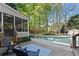 Charming backyard featuring a swimming pool, hot tub, outdoor seating, and lush landscaping at 2040 Parliament Dr, Lawrenceville, GA 30043