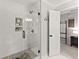 Sleek tiled shower with glass enclosure, black fixtures, and a decorative tiled floor at 2040 Parliament Dr, Lawrenceville, GA 30043