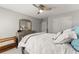 Well-lit bedroom featuring a ceiling fan, a dresser with mirror, and comfortable bedding at 2040 Parliament Dr, Lawrenceville, GA 30043
