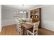 Formal dining room featuring a rustic wood table, elegant decor, and hardwood floors at 2040 Parliament Dr, Lawrenceville, GA 30043