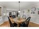 Cozy dining area adjacent to the kitchen, ideal for Gathering meals and entertaining guests, with hardwood floors at 2040 Parliament Dr, Lawrenceville, GA 30043