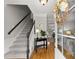 Elegant foyer featuring hardwood floors, staircase, and stylish decor at 2040 Parliament Dr, Lawrenceville, GA 30043