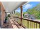 Inviting front porch with wooden decking, decorative columns, and serene neighborhood views at 2040 Parliament Dr, Lawrenceville, GA 30043