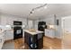 Beautiful kitchen with white cabinets, dark appliances, and center island for efficient food preparation and casual dining at 2040 Parliament Dr, Lawrenceville, GA 30043