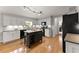 Well-appointed kitchen showcasing white cabinets, black appliances, granite countertops, and a functional center island at 2040 Parliament Dr, Lawrenceville, GA 30043
