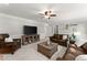 Inviting living room with leather seating, ceiling fan, and built-in media center for relaxing and entertaining at 2040 Parliament Dr, Lawrenceville, GA 30043