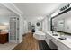 Bright main bathroom featuring a soaking tub, double sinks, and stylish wood-look flooring at 2040 Parliament Dr, Lawrenceville, GA 30043