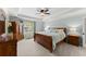 Serene main bedroom with tray ceiling, a sitting area, and ample natural light for a relaxing retreat at 2040 Parliament Dr, Lawrenceville, GA 30043