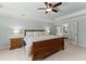 Bright main bedroom with tray ceilings, fan, and a cozy bed, perfect for relaxation at 2040 Parliament Dr, Lawrenceville, GA 30043