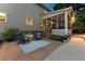 Charming patio space with blue Adirondack chairs, a screened-in porch, and stylish outdoor decor at 2040 Parliament Dr, Lawrenceville, GA 30043