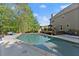 A refreshing backyard pool surrounded by lush greenery, concrete pool deck and lounge chairs at 2040 Parliament Dr, Lawrenceville, GA 30043