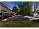 Enjoy this refreshing backyard pool, complemented by mature trees and comfortable lounge chairs for ultimate relaxation at 2040 Parliament Dr, Lawrenceville, GA 30043
