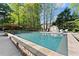 Enjoy a refreshing backyard pool surrounded by stone accents, a lush lawn and comfortable lounge seating at 2040 Parliament Dr, Lawrenceville, GA 30043