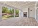 View of back porch with brick fireplace, covered patio, and wooded backyard at 2841 Bettis Ct, Marietta, GA 30066