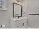 Modern bathroom featuring a white vanity with black hardware and a framed mirror at 2841 Bettis Ct, Marietta, GA 30066