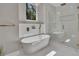 Bright bathroom featuring a soaking tub under a chandelier and a glass-enclosed shower at 2841 Bettis Ct, Marietta, GA 30066