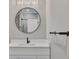 Modern bathroom featuring white cabinets, round mirror, and elegant fixtures at 2841 Bettis Ct, Marietta, GA 30066