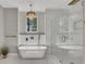 Bright bathroom featuring a soaking tub under a chandelier and a glass-enclosed shower at 2841 Bettis Ct, Marietta, GA 30066