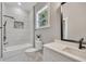 Bright bathroom with a tub, white tiled shower, and stylish vanity with stone countertop at 2841 Bettis Ct, Marietta, GA 30066