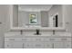 Bathroom with double sink vanity, white marble countertop, gold hardware, and decorative framed mirror at 2841 Bettis Ct, Marietta, GA 30066