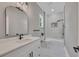 Beautiful bathroom with modern vanity, framed mirror, and tiled tub with shower combo at 2841 Bettis Ct, Marietta, GA 30066