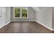 Cozy bedroom featuring hardwood flooring, trim and a double window overlooking the yard at 2841 Bettis Ct, Marietta, GA 30066