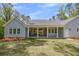 Covered patio with brick flooring and white columns with a fireplace at 2841 Bettis Ct, Marietta, GA 30066