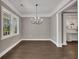 Dining room with hardwood floors, crown molding, a modern chandelier, and natural light at 2841 Bettis Ct, Marietta, GA 30066