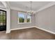 Dining room with hardwood floors, a modern chandelier, and a large window with backyard view at 2841 Bettis Ct, Marietta, GA 30066