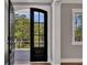 Elegant entryway showcasing a black arched glass paneled front door leading to a covered porch at 2841 Bettis Ct, Marietta, GA 30066
