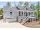 Charming two-story home featuring a welcoming front porch, gray siding, and an attached two car garage at 2841 Bettis Ct, Marietta, GA 30066