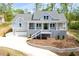 Charming two-story home featuring a welcoming front porch, gray siding, and an attached two car garage at 2841 Bettis Ct, Marietta, GA 30066