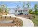 Beautiful two-story home featuring a welcoming front porch, gray siding, landscaping, and a long driveway at 2841 Bettis Ct, Marietta, GA 30066
