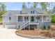 Charming two-story home featuring a welcoming front porch, gray siding, and an attached two car garage at 2841 Bettis Ct, Marietta, GA 30066