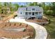Beautiful two-story home featuring a welcoming front porch, gray siding, landscaping, and a long driveway at 2841 Bettis Ct, Marietta, GA 30066