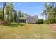 Rear exterior view of the home featuring a light gray facade and expansive lawn at 2841 Bettis Ct, Marietta, GA 30066