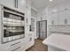 A close up of a modern kitchen featuring stainless steel appliances and white cabinetry with black hardware at 2841 Bettis Ct, Marietta, GA 30066