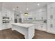 This modern kitchen boasts white cabinets, stainless steel appliances, and a large center island with quartz countertops at 2841 Bettis Ct, Marietta, GA 30066