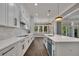 This kitchen features white cabinets, stainless steel appliances, and a view of the backyard from the open layout at 2841 Bettis Ct, Marietta, GA 30066