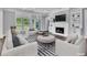 A beautifully staged living room shows a fireplace, built-in shelving, and backyard views at 2841 Bettis Ct, Marietta, GA 30066