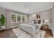 This bedroom features a comfortable bed, modern decorations, and windows looking out on the natural landscape at 2841 Bettis Ct, Marietta, GA 30066